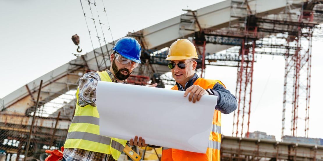 construction-workers-looking-over-the-blueprints