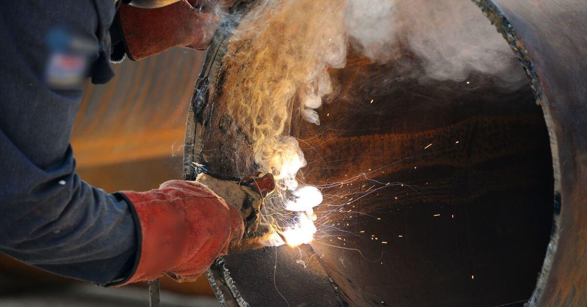 a-pipefitter-hand-welding-a-pipe-for-a-steel-mill-project